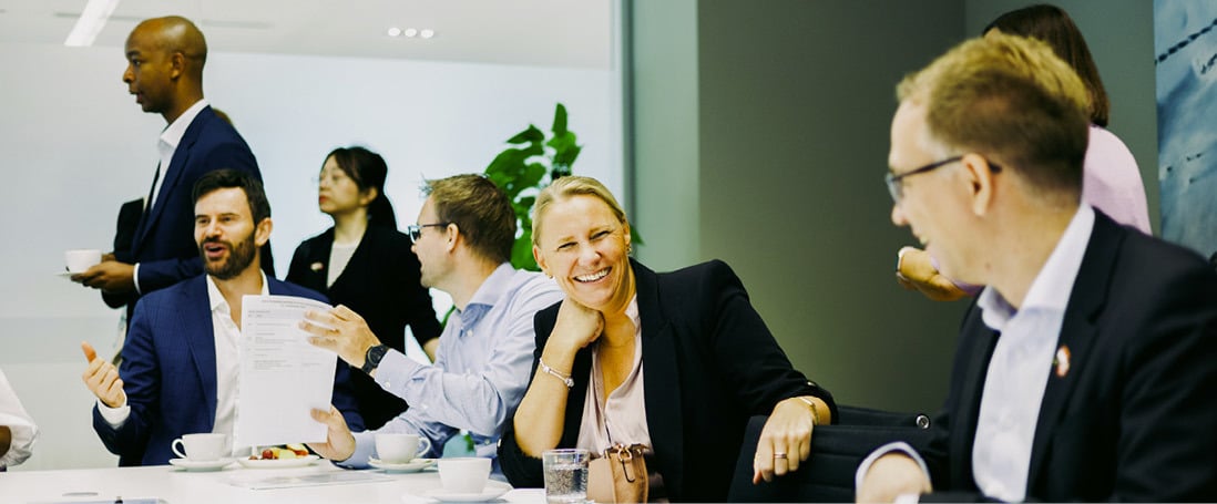 A group of people engaged in a meeting at the Singapore office.