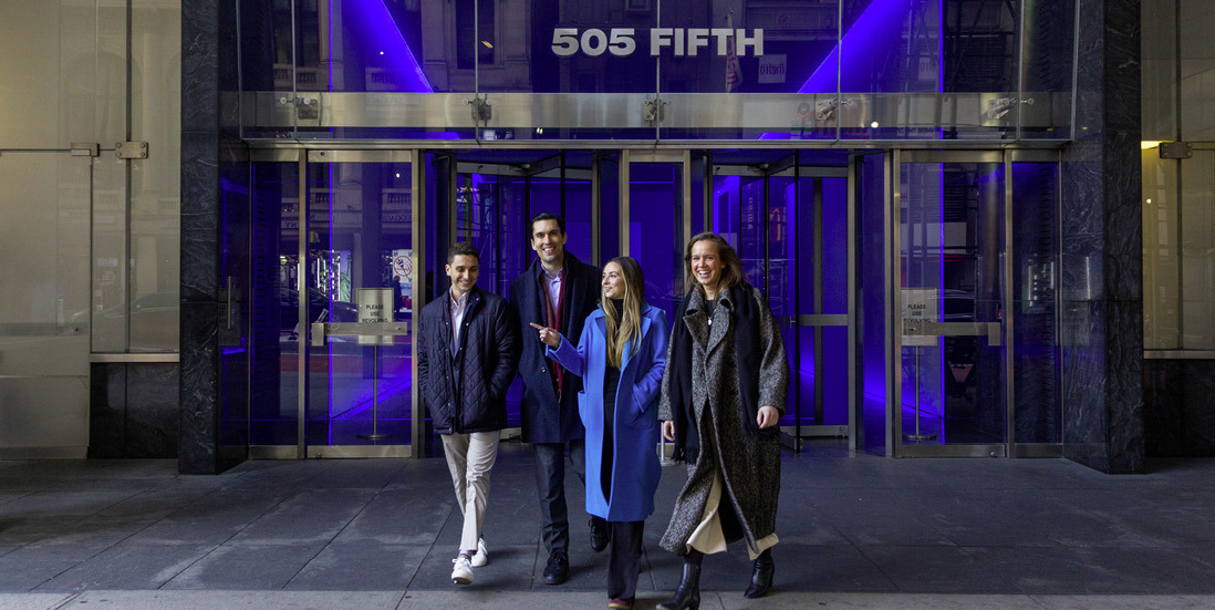 Four Norges Bank Investment Management employees walk out of a building entrance at 505 Fifth Avenue.