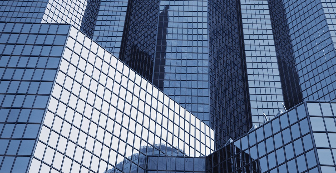 Glass skyscrapers reflecting the surrounding cityscape.