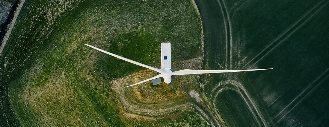 Aerial view of wind turbine in a field.