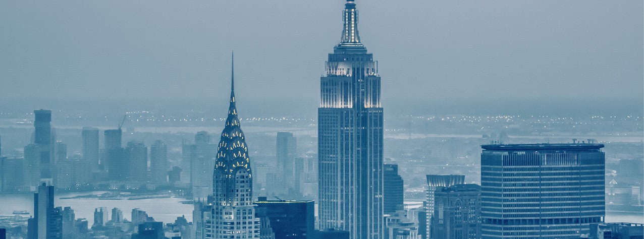 Manhattan with Empire State Building and Chrysler Building in bluish haze.